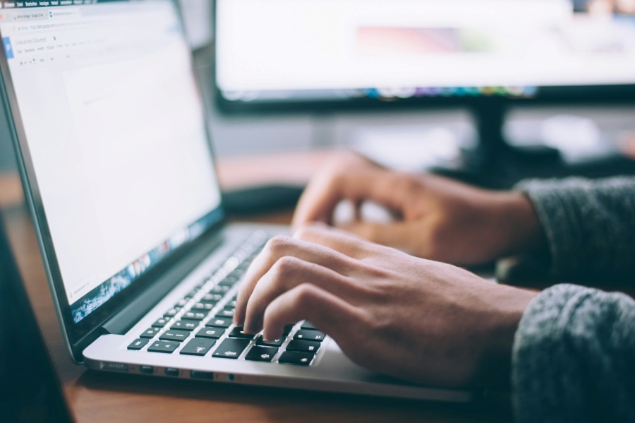 Close up of hands using a laptop