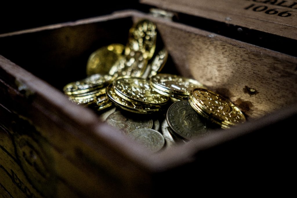 Pile of gold coins in a treasure box