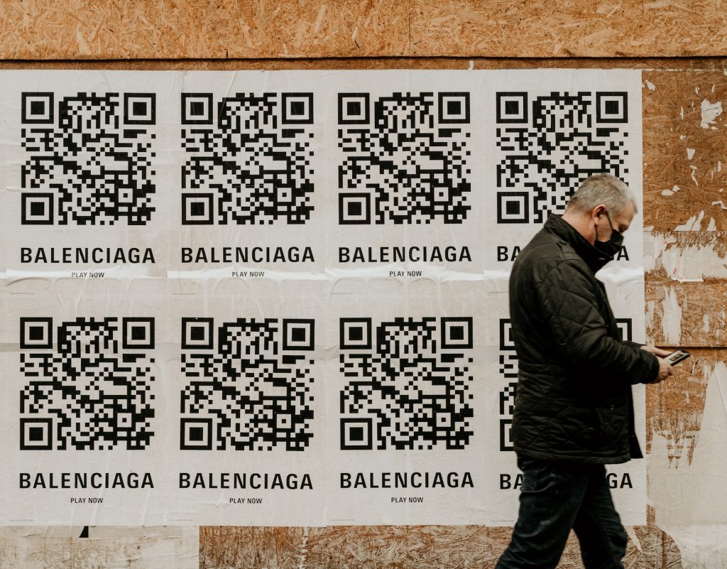 man walking in front of advertising signs